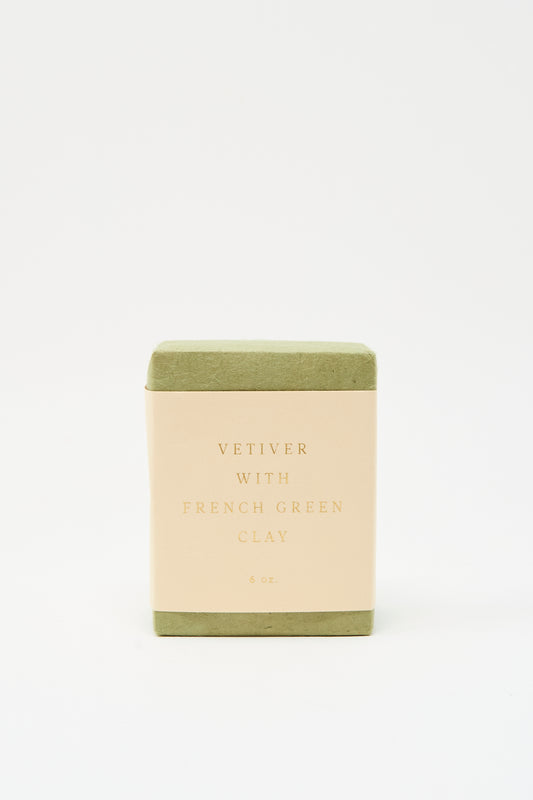 A rectangular bar of SAIPUA Soap in Vetiver with French Green Clay is shown against a white background, featuring green edges and a cream label—ideal for sensitive skin.