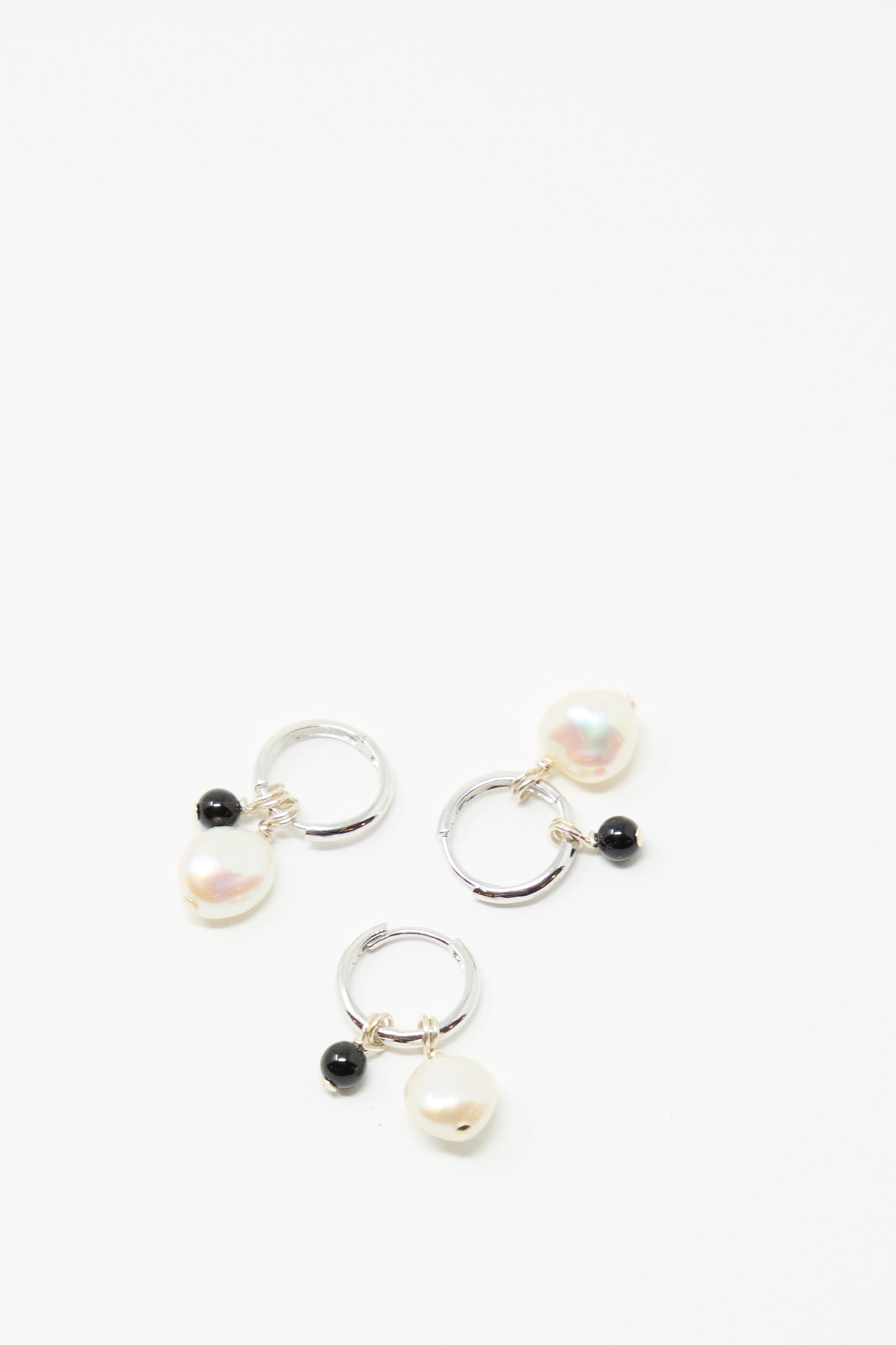 Santangelo's Baba Earrings in Baby Black Agate: three handmade sterling silver hoops, each with a white pearl and small black agate stone, made in NYC and shown on a plain white background.