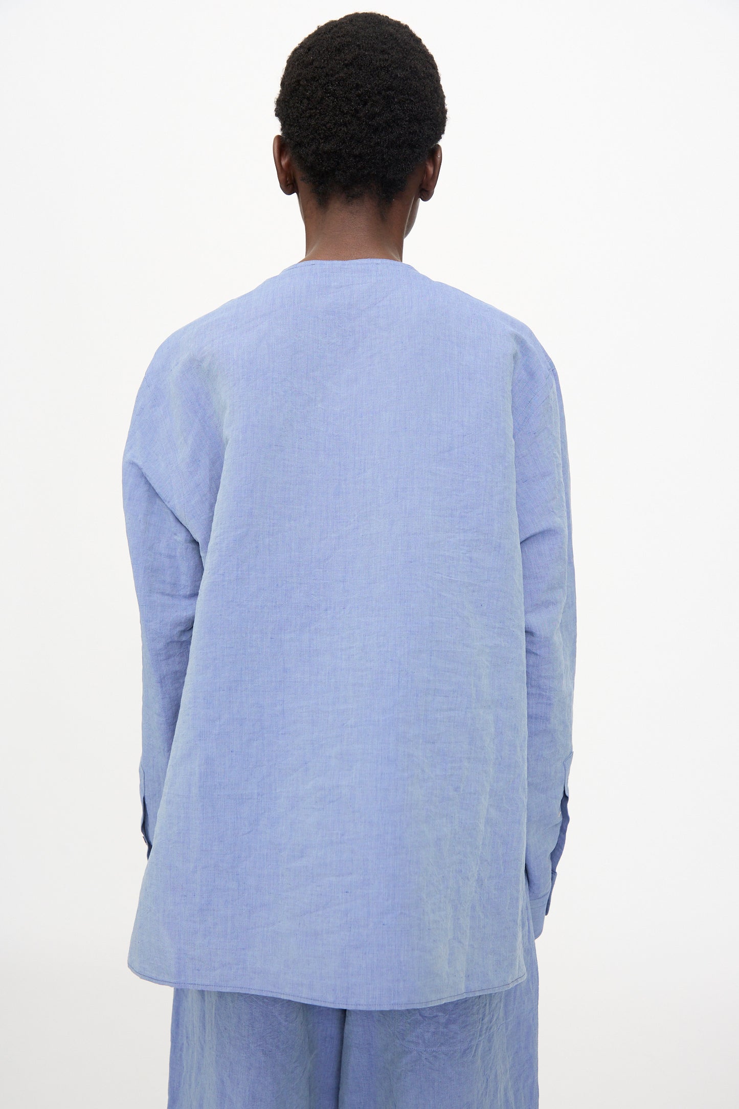 A person is shown from behind wearing the Sofie D'Hoore Barel Crewneck in Blue Jeans, featuring a relaxed fit and long sleeves, against a plain white background.