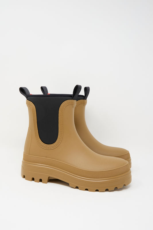 The Sofie D'Hoore Falk Rainboot in Caramel features water-repellent rubber, black elastic side panels, and pull tabs at the ankle, shown against a plain white background.