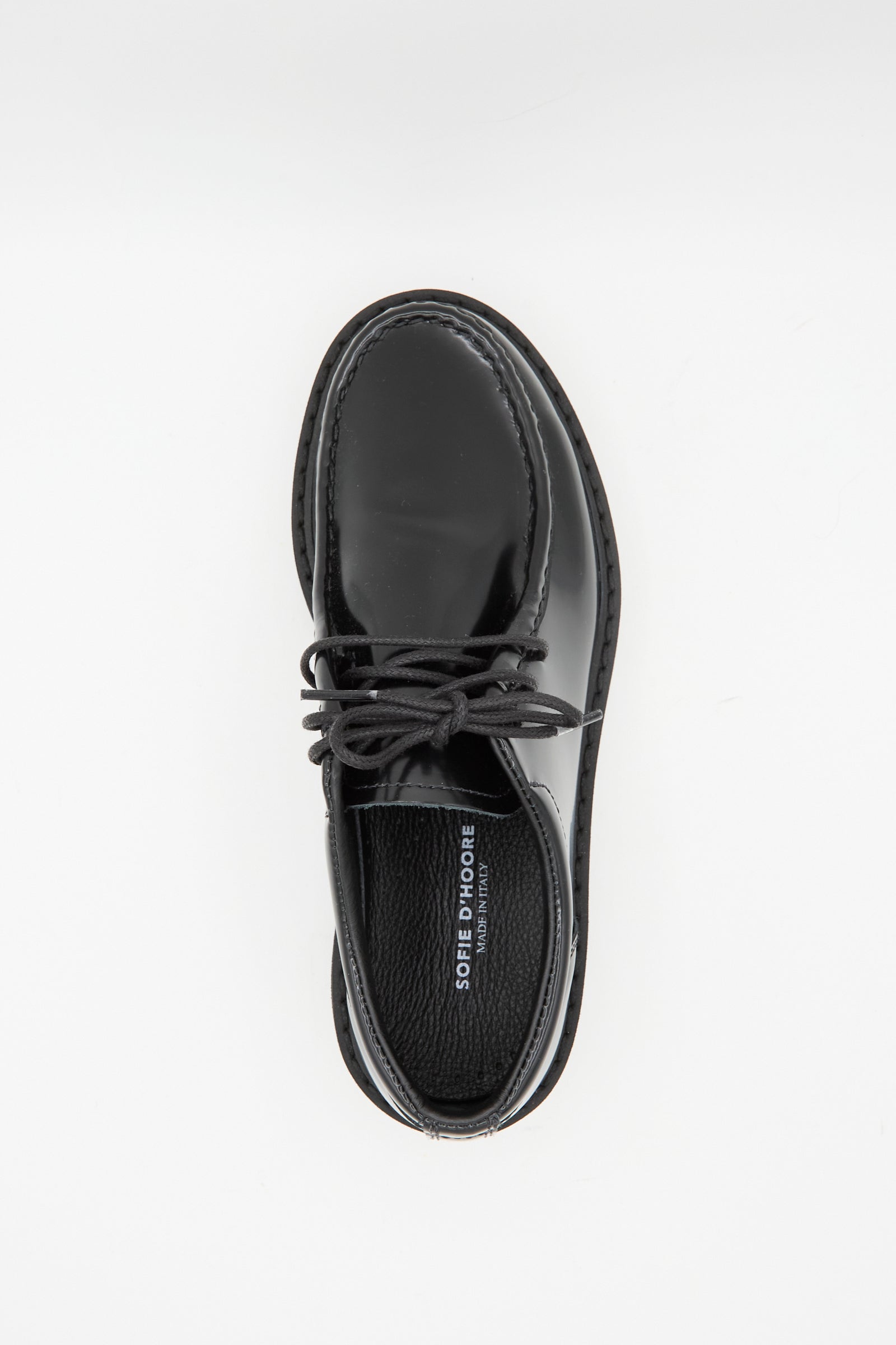 The Sofie D'Hoore Leather Falcone Wallabee Shoe in Black, featuring patent leather and rubber soles, is photographed from above on a white background.