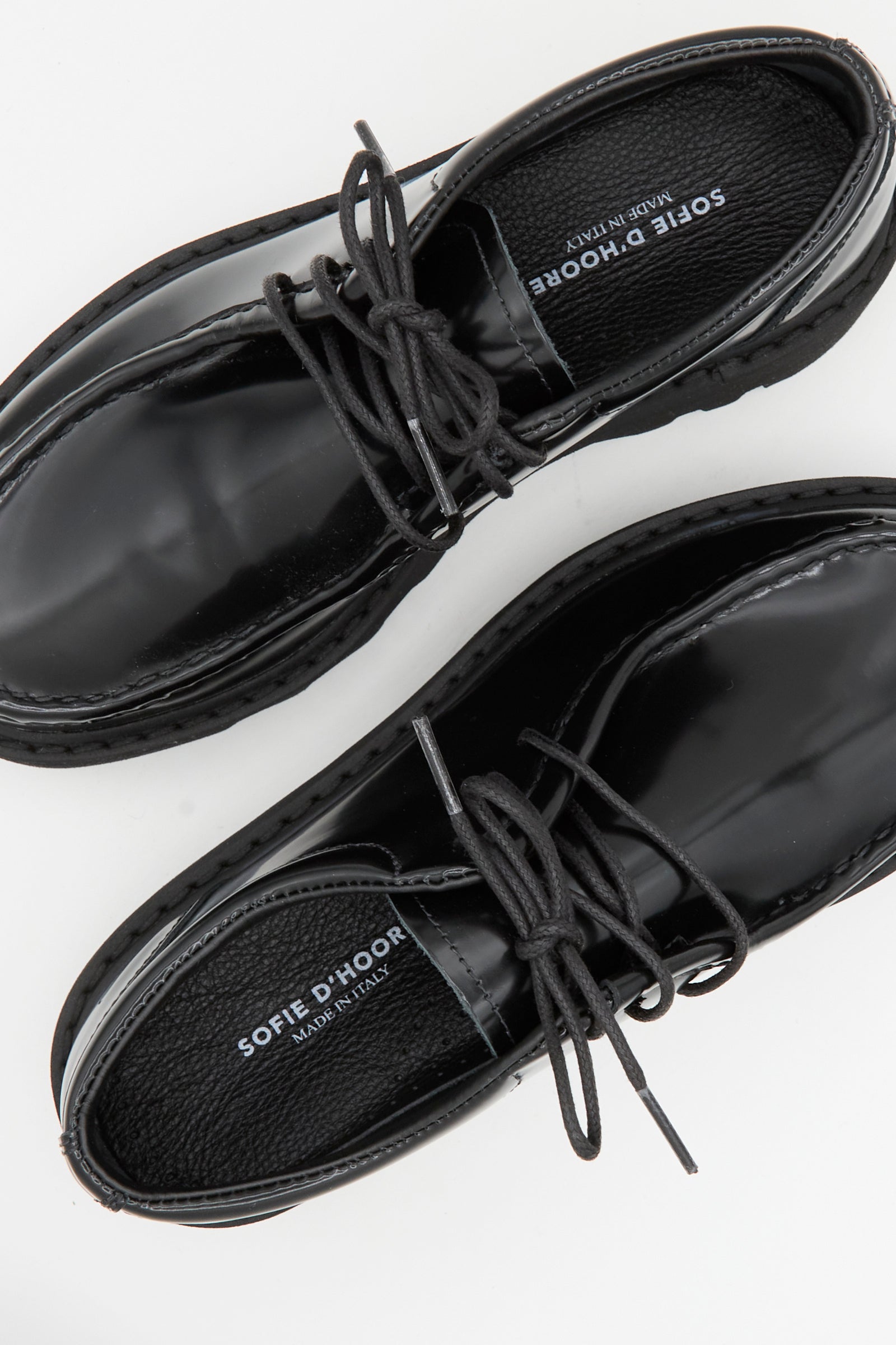 The Leather Falcone Wallabee Shoe in Black by Sofie D'Hoore is shown from above on a white background, featuring black leather, visible stitching, lace-up design, and rubber soles.