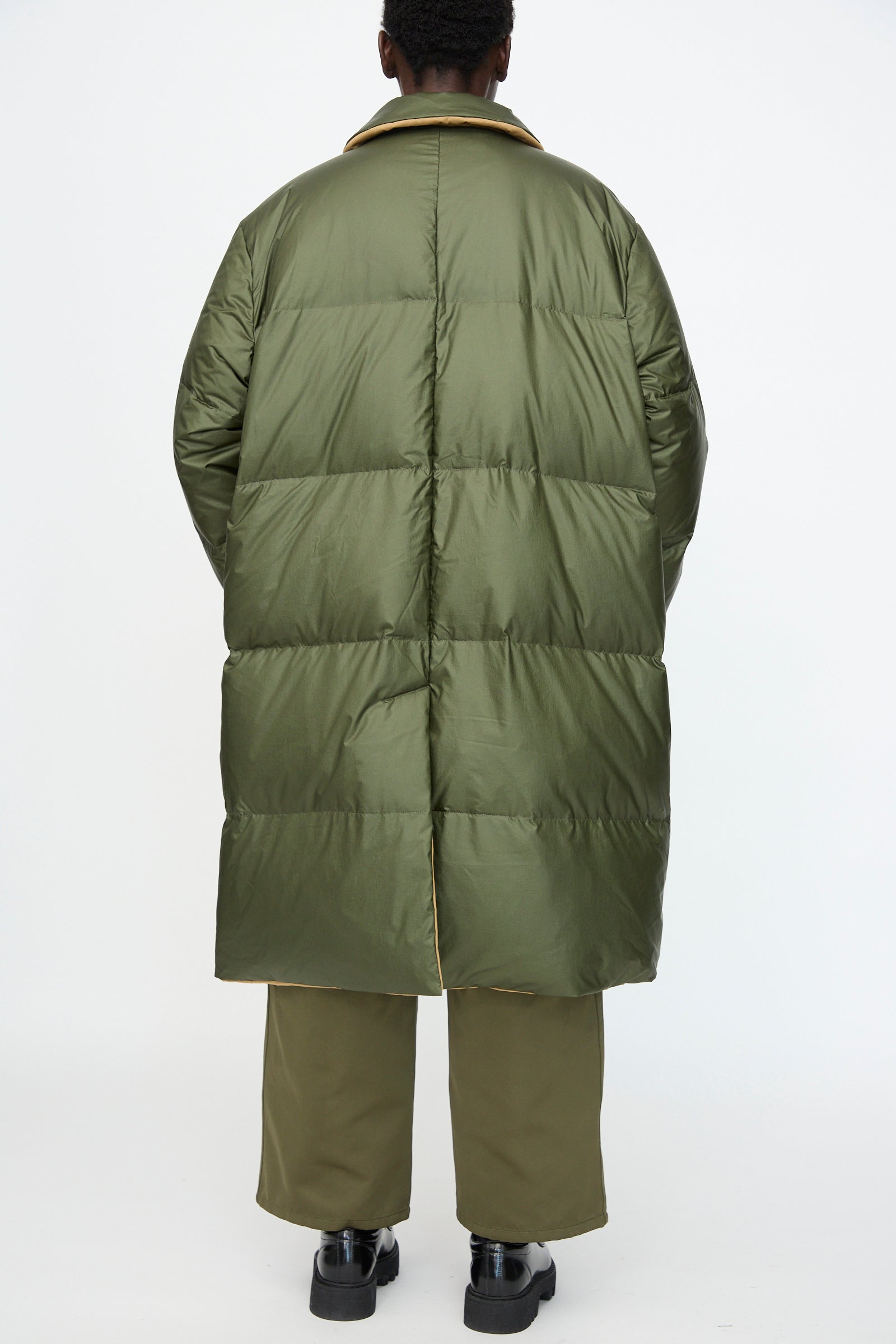 Model wears Sofie D'Hoore Reversible Otis Down Coat in Mushroom and Khaki, photographed from the back against a plain white background.