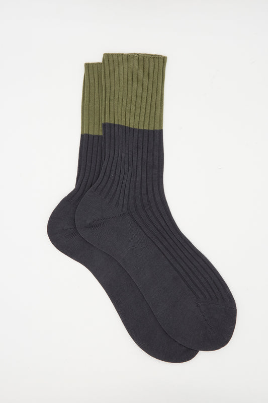 The Sofie D'Hoore Rib Four Socks in Olive and Charcoal, made in Italy, feature ribbed detailing with olive tops and charcoal feet and legs. Shown flat on a white background.