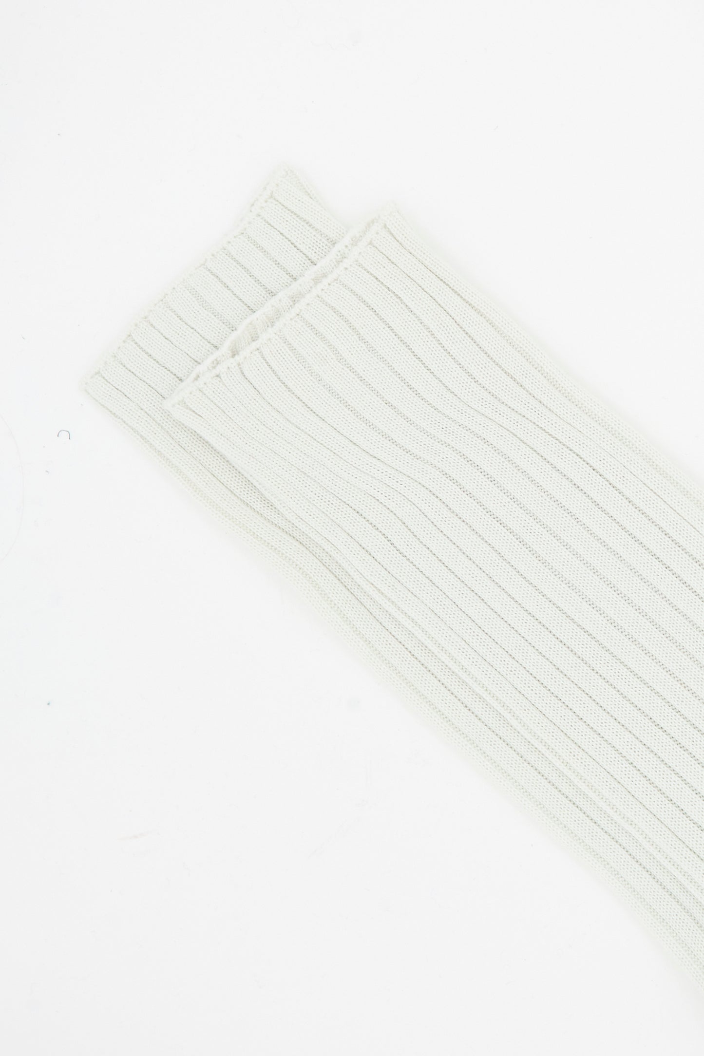 A close-up of two folded Ribbed Friday Socks in Mastic and Peanut by Sofie D'Hoore on a plain white background.