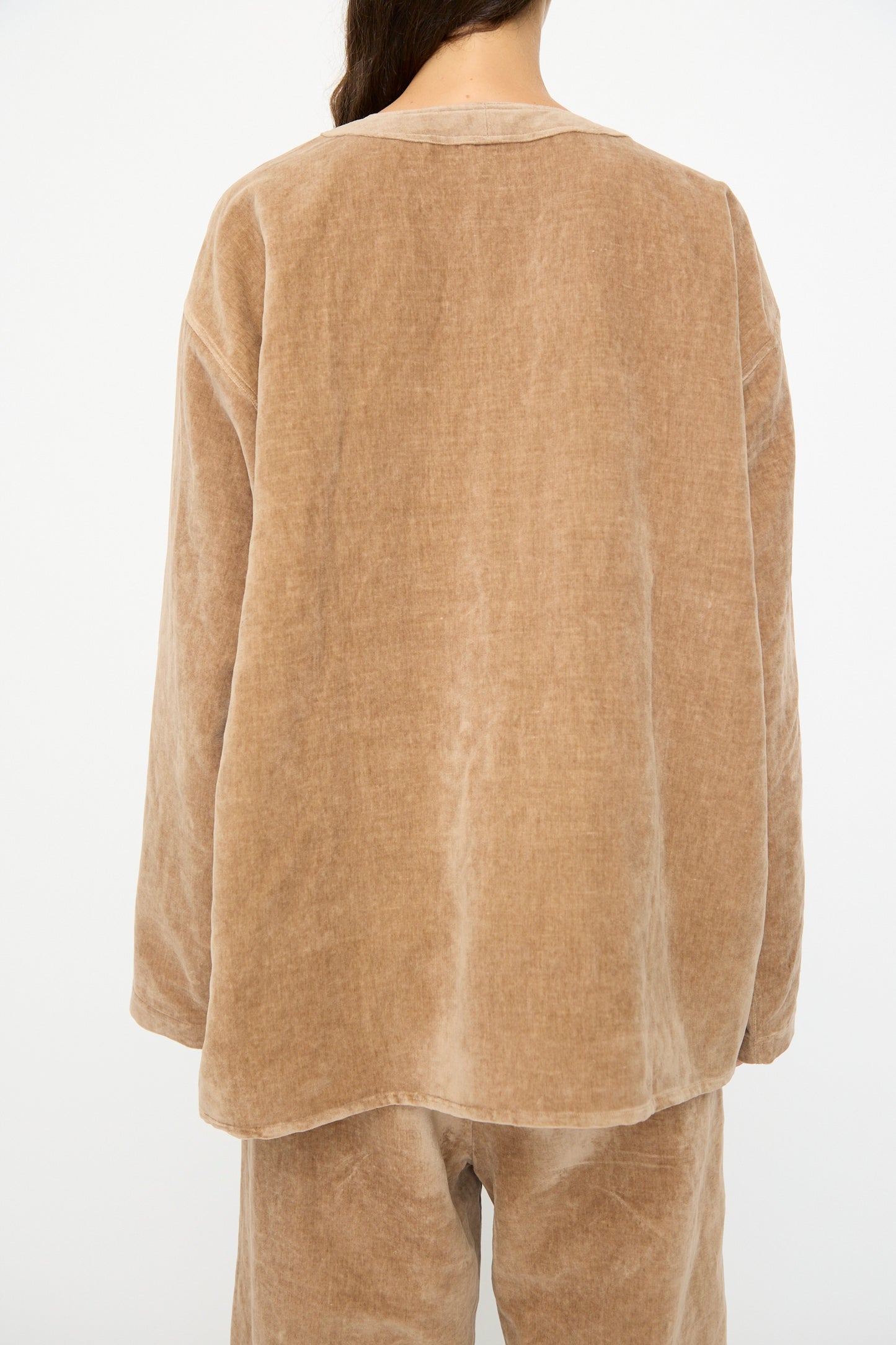 A person wearing the SONO Sid Shirt in Desert Rose, relaxed fit, shown from behind against a plain background.