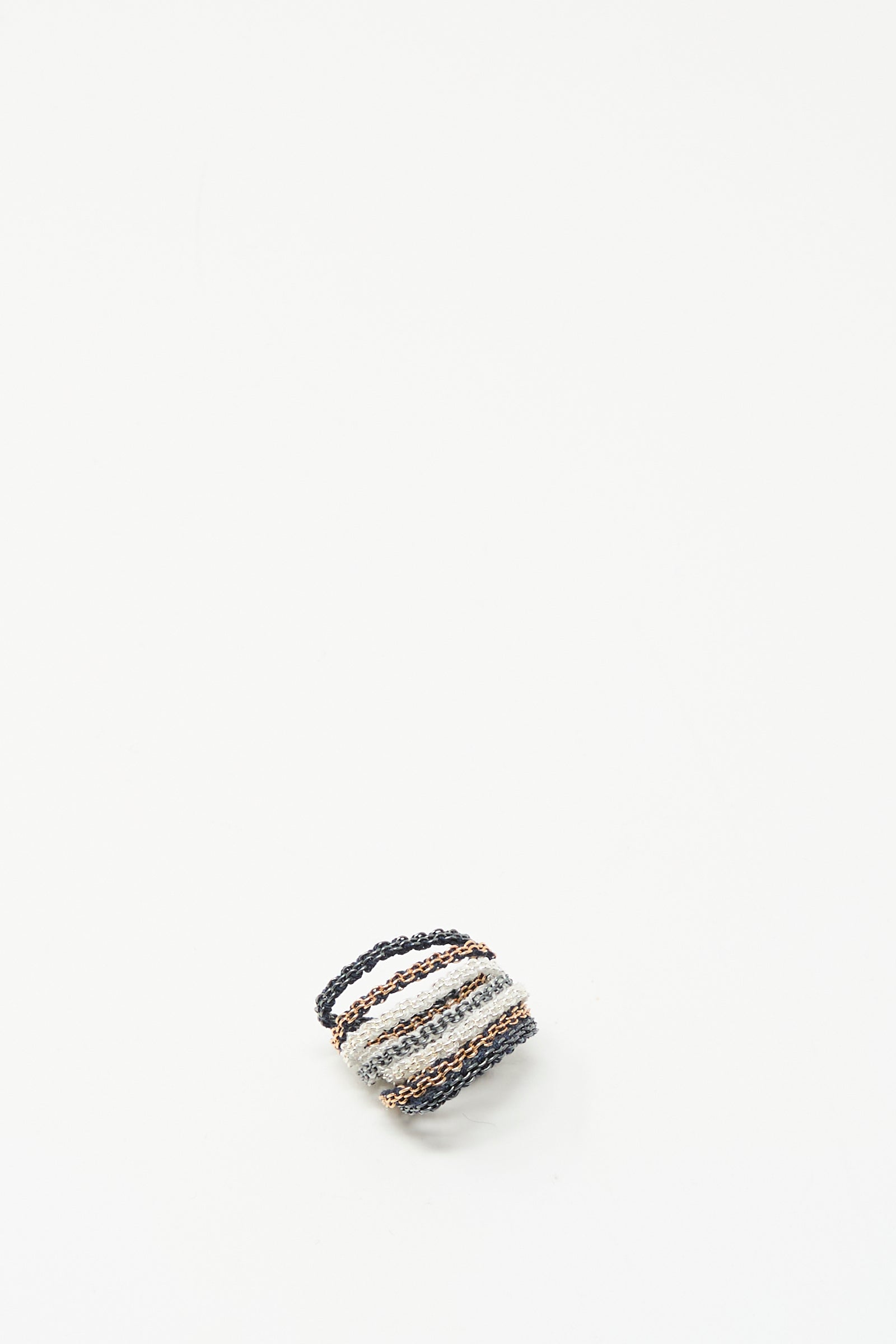 A Silver, Rose Gold Plated and Silk Woven Ring by Stephanie Schneider, featuring a small rectangular shape and striped design with a loop handle, sits on a white background.