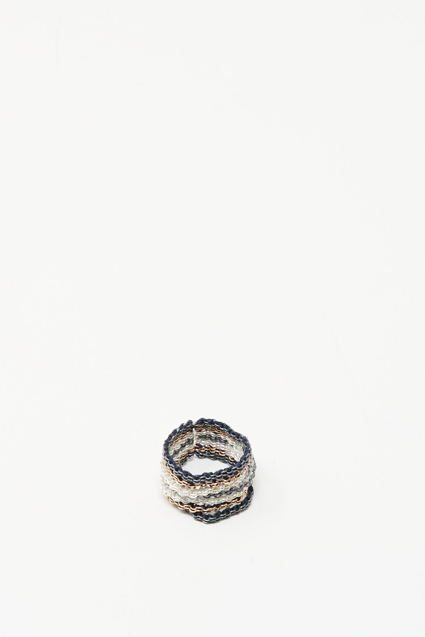 The Stephanie Schneider Silver, Rose Gold Plated and Silk Woven Ring features intertwined silver, rose gold-plated metal, and silk on a white background.