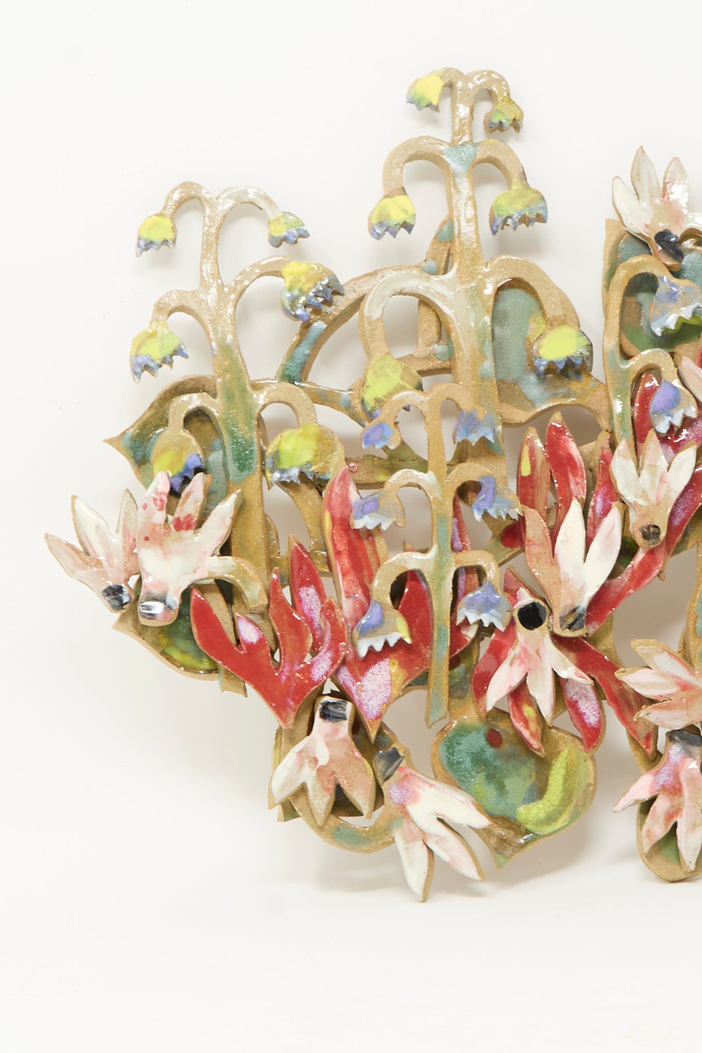 Handmade in Brooklyn by Tamar Mogendorff, the My Garden is on Fire Wall Relief showcases abstract red, white, and blue flowers with green stems and leaves set against a plain white background—a striking ceramic wall hanging ideal for any contemporary space.