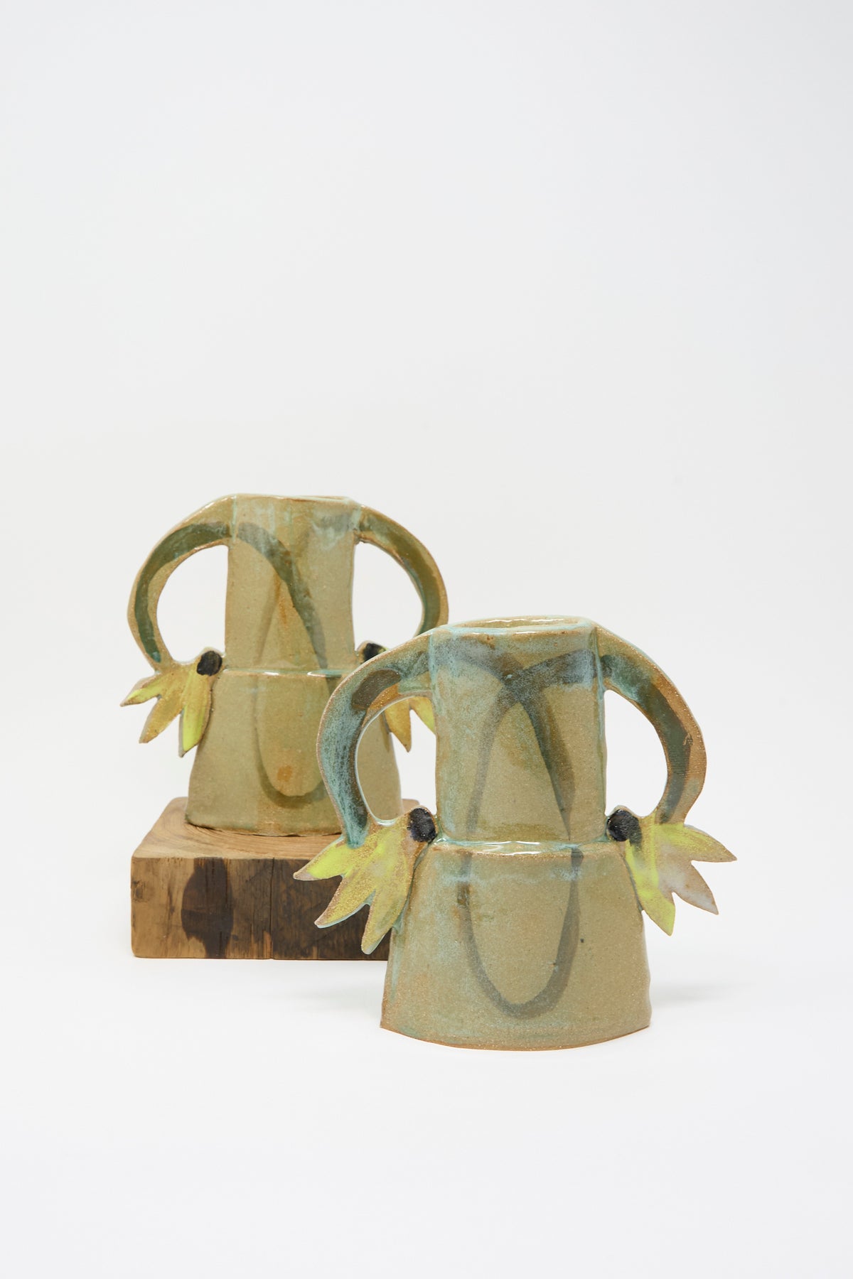 Two Cyclamens Vase in Celadon Green I: two handmade celadon green ceramic vases featuring arched handles with leaf-like accents.