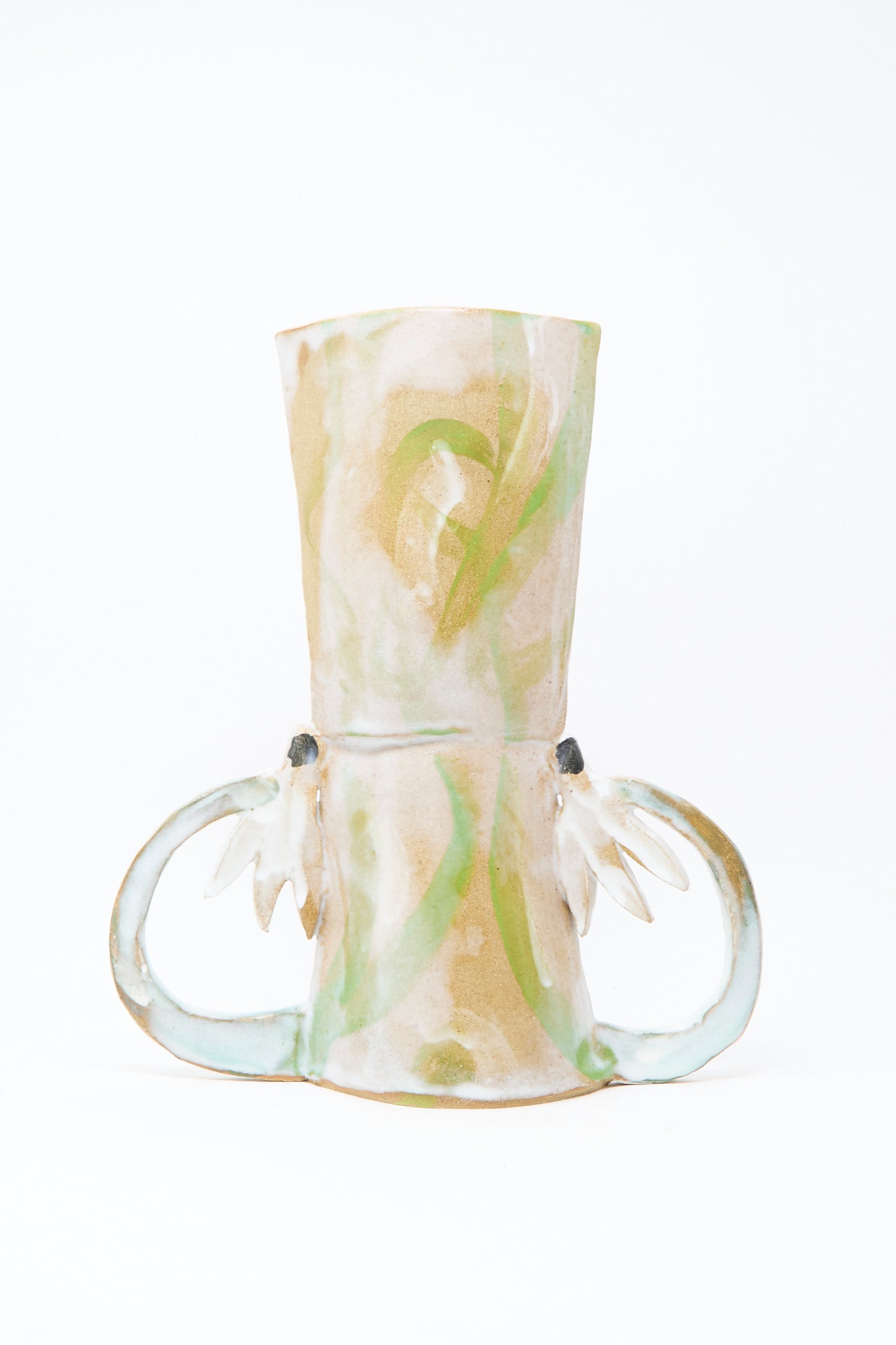 The Two Cyclamens by the Lake Vase by Tamar Mogendorff is a handmade ceramic piece from Brooklyn with two large curved handles and abstract green and beige patterns on white.