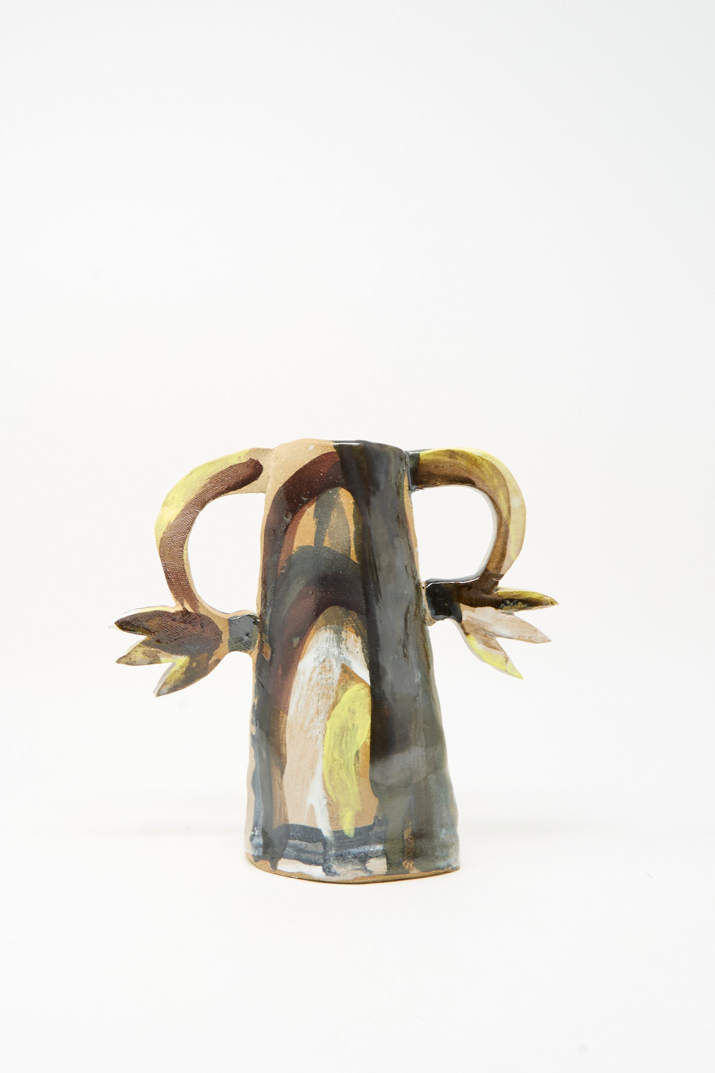 Handmade in Brooklyn by Tamar Mogendorff, the Two Cyclamens on Top of a Mountain Vase features two side handles shaped like horns and leaves, adorned with an abstract, multicolored painted design. The artisan ceramic vase is photographed against a plain white background.