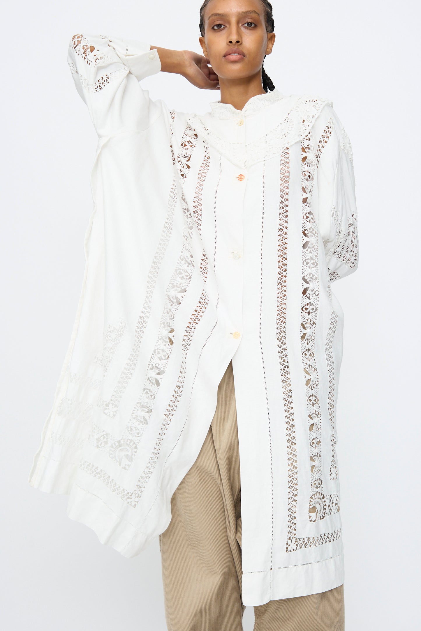 Model wears the Ruffle Oversized Oxford by Thank You Have A Good Day, featuring lace details, paired with beige wide-leg pants against a plain background.
