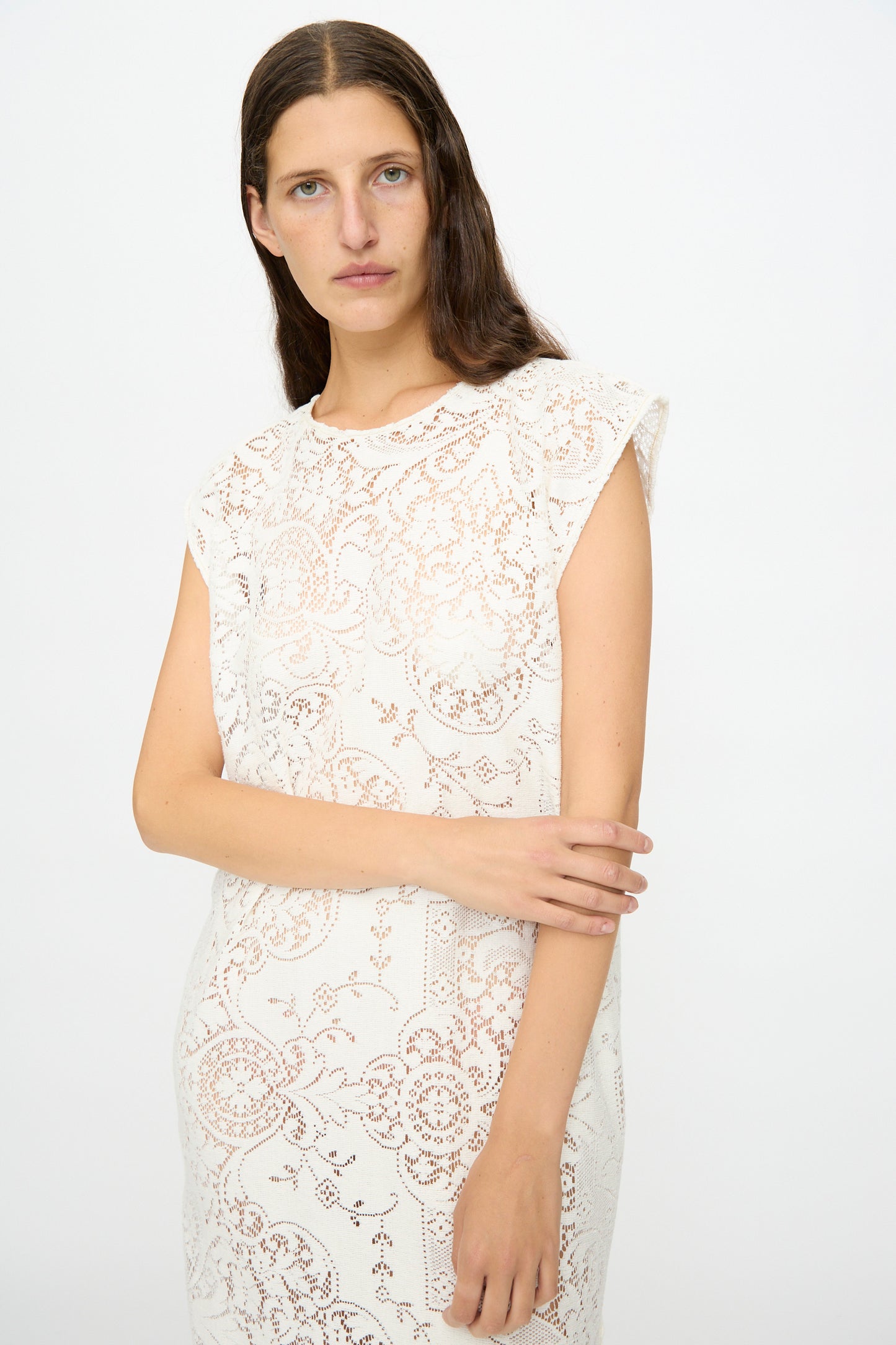 A person with long brown hair models the Quaker Lace Caftan by Thank You Have A Good Day— a sleeveless, white dress— against a plain white background.