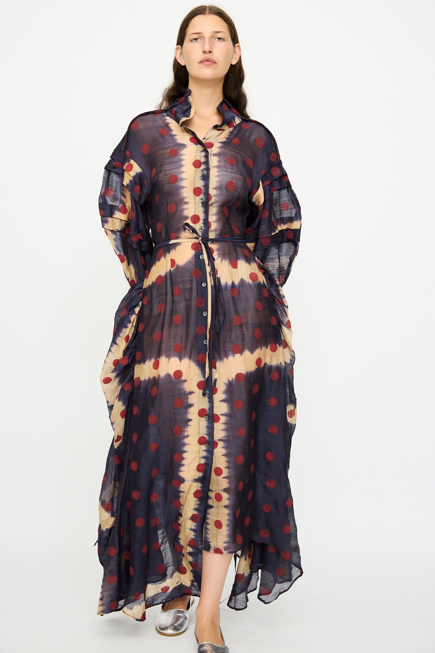 A woman wears the TIGRA TIGRA Silk Chanderi Teatime Dress in Navy, Cream, and Red, featuring a tie waist. She stands against a plain white background.