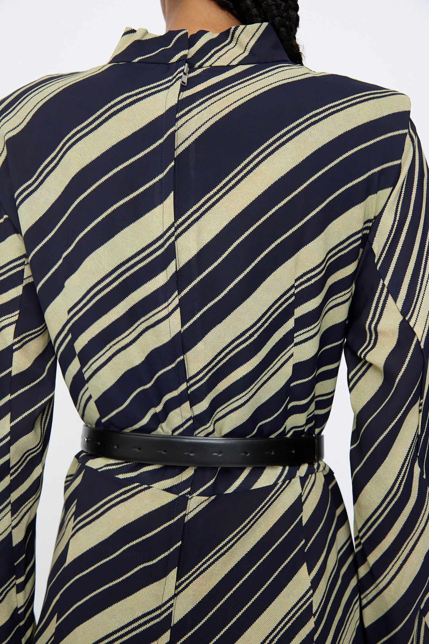 A person is seen from the back wearing a black and beige striped blazer, cinched at the waist with the TOGA ARCHIVES Double Buckle Belt in Black.