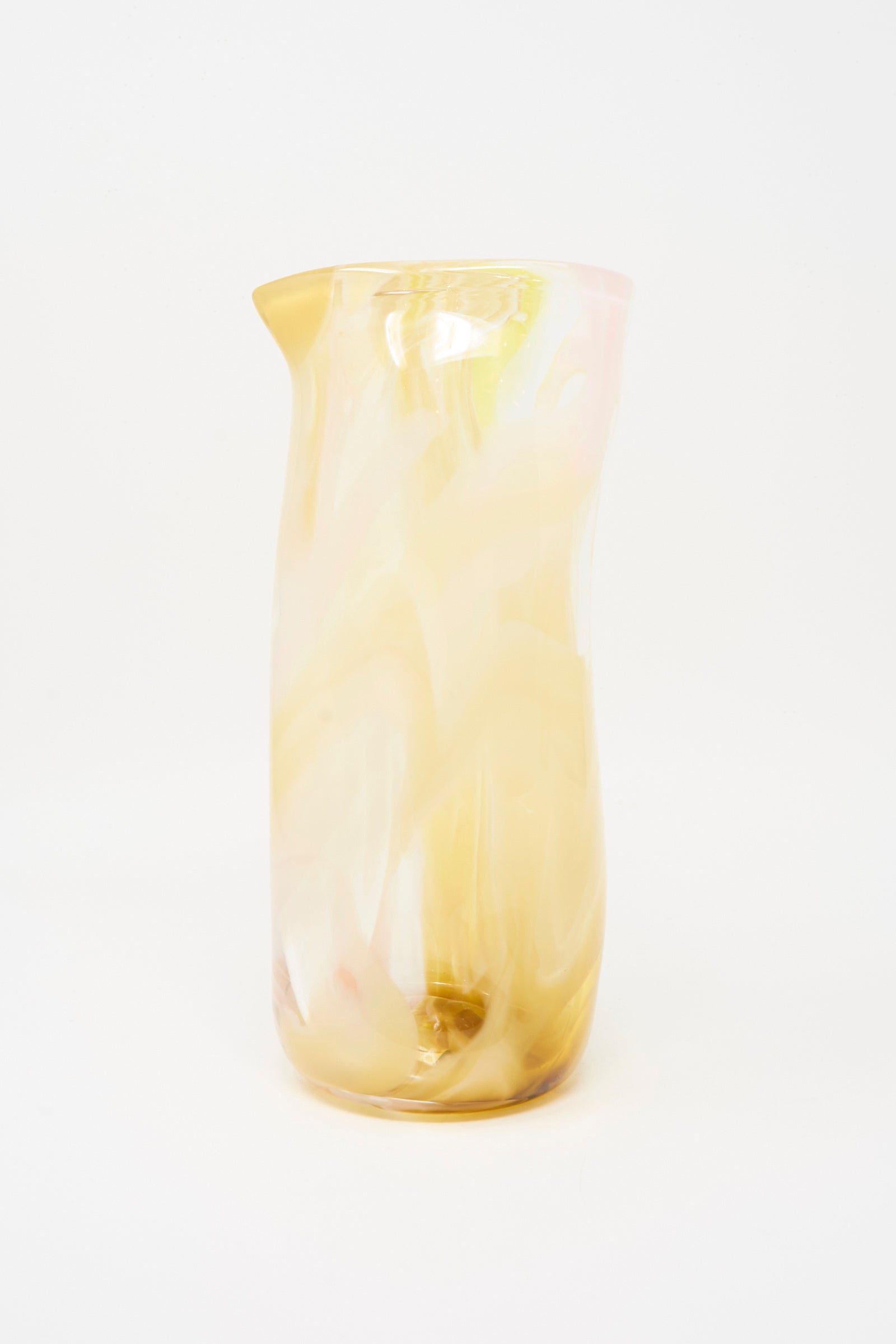 The Upstate Hand Blown Carafe in Frankie features a tall, translucent design with a marbled pattern in soft yellow and pink tones, set against a plain white background.