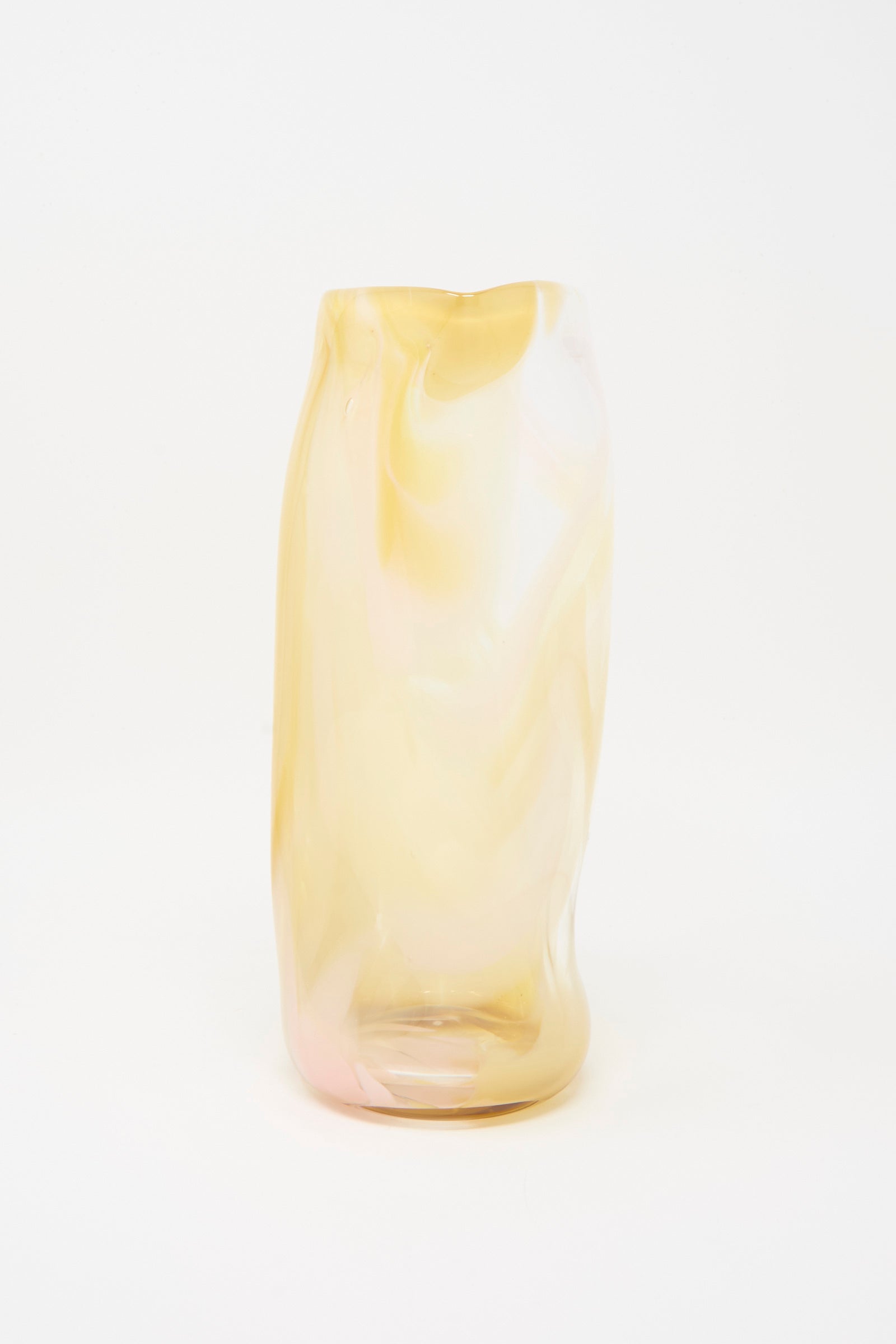 The Upstate Hand Blown Carafe in Frankie features a tall, uniquely shaped design with a smooth, marbled surface in pale yellow and white tones, set against a plain white background.