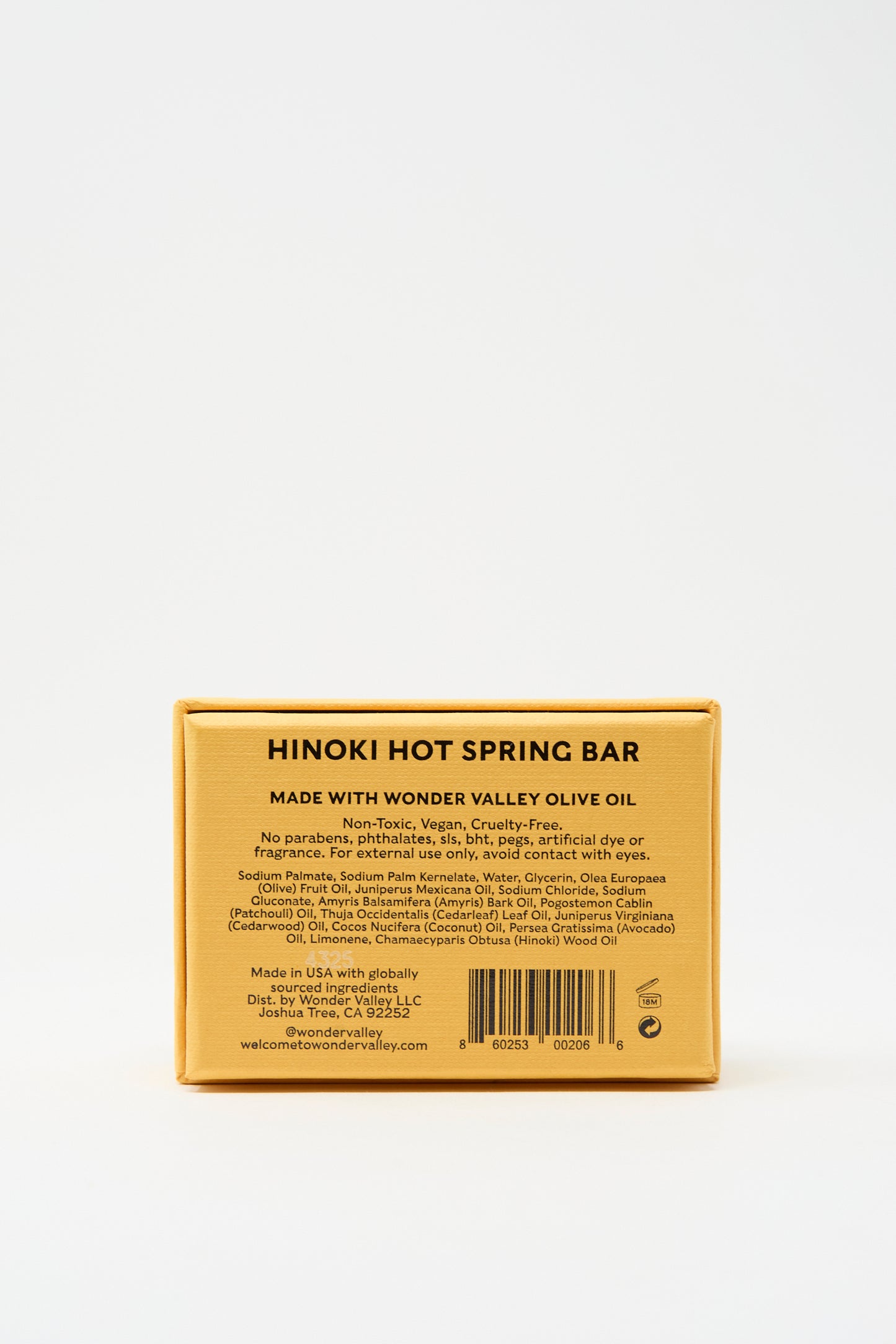 Rectangular yellow box labeled “Hinoki Bar Soap” by Wonder Valley. Vegan, cruelty-free, and non-toxic soap with extra virgin olive oil, featuring a hinoki cedar scent. Ingredients and details listed on packaging.