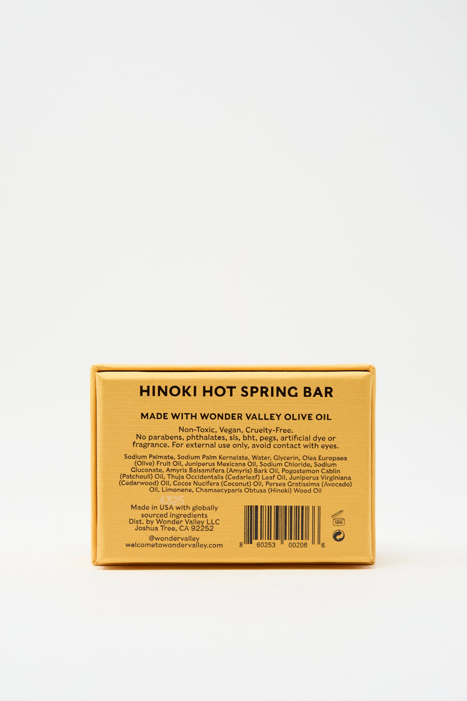 Rectangular yellow box labeled “Hinoki Bar Soap” by Wonder Valley. Vegan, cruelty-free, and non-toxic soap with extra virgin olive oil, featuring a hinoki cedar scent. Ingredients and details listed on packaging.