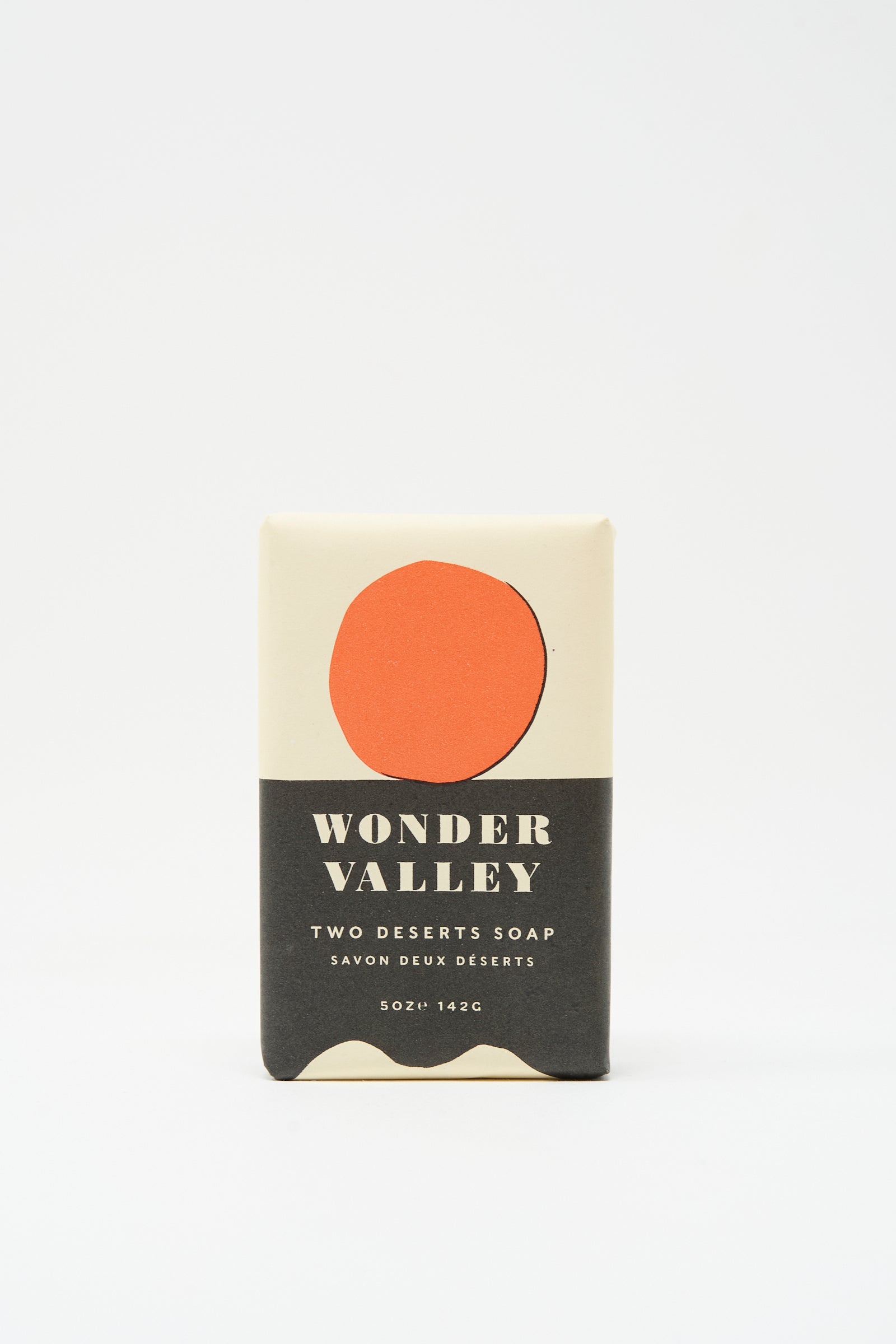 Wonder Valley’s Two Deserts Soap is a plant-based bar soap made with Wonder Valley Olive Oil, packaged in minimalist beige wrapping with a red circle and black text.