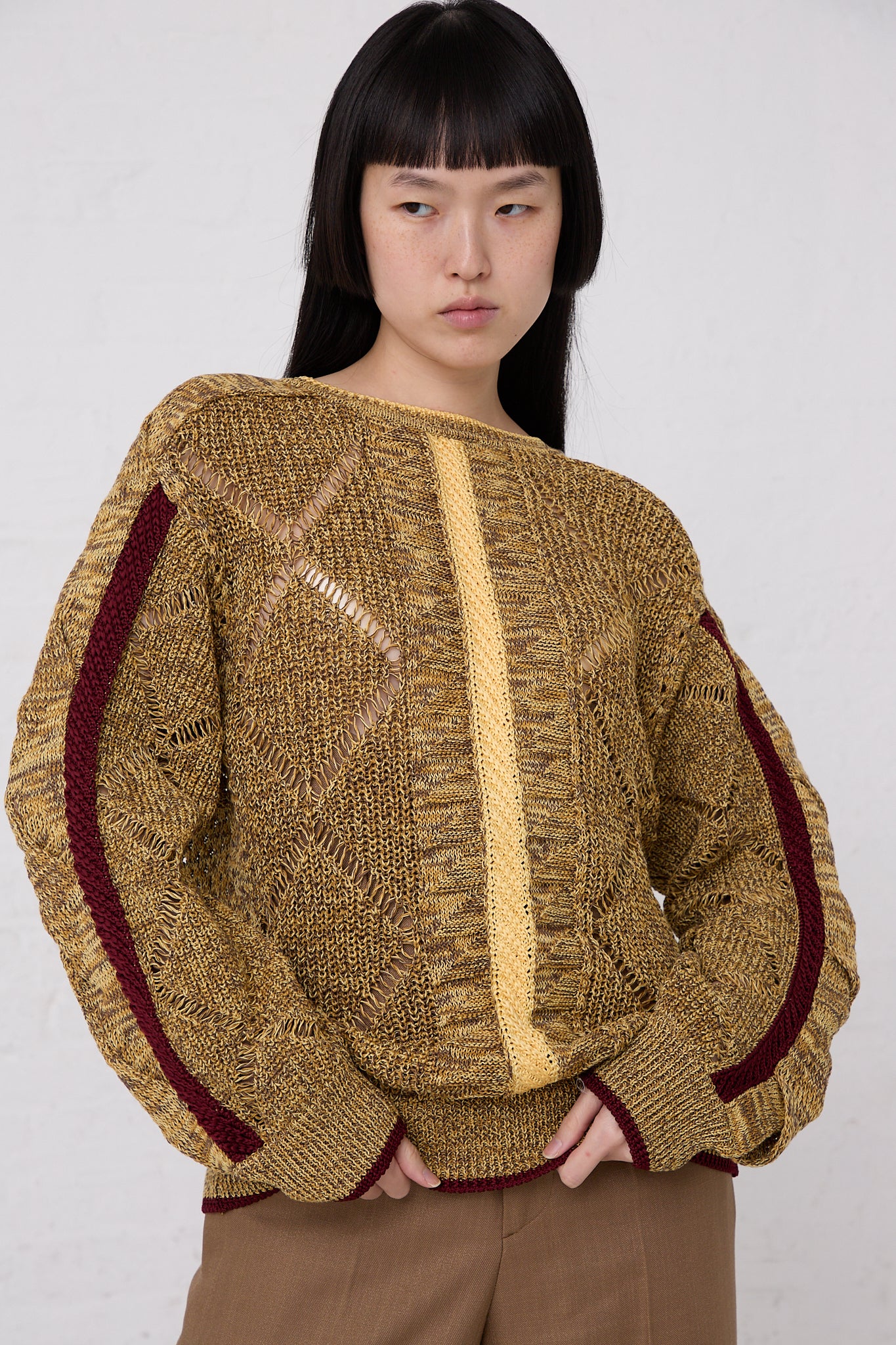 A woman posing for a picture in a TOGA ARCHIVES Mesh Knit Pullover in Yellow.