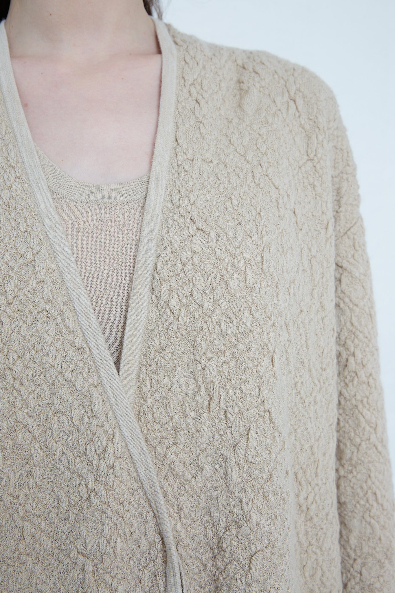 A woman wearing an Alpaca Gauze Cardigan in Antique by Lauren Manoogian, made from sustainable production. Front view and up close of detail.