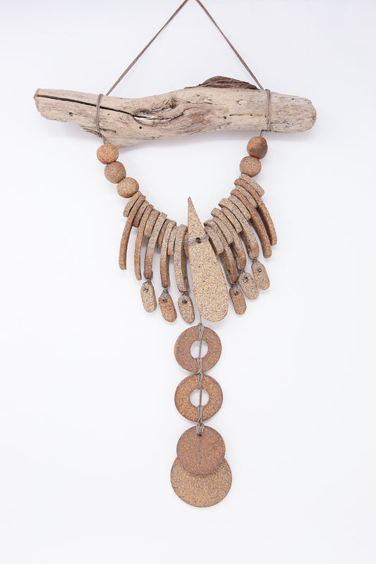 The Teardrop and Circle Wall Hanging in Mixed Brown by Heather Levine, handmade in California, showcases a cascading design of driftwood and metal ornaments, elegantly suspended by twine against a plain white background.