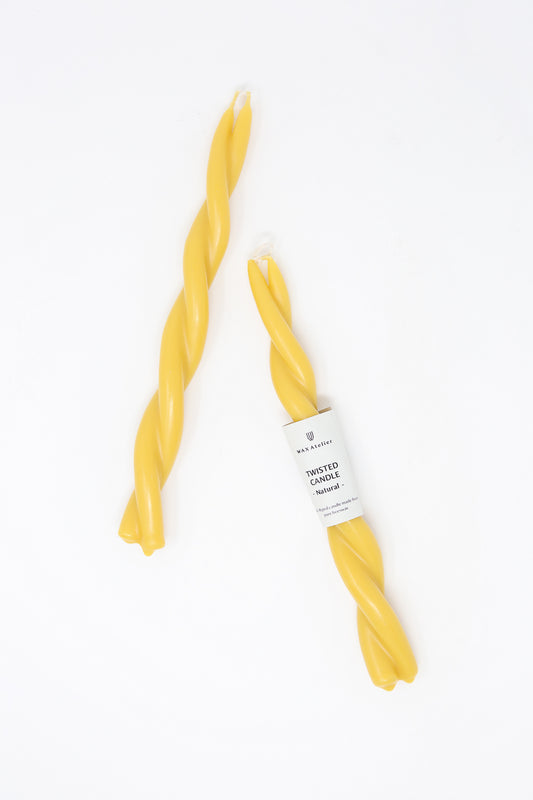Two Hand Twisted Beeswax Candles in Natural by Wax Atelier on a white background.