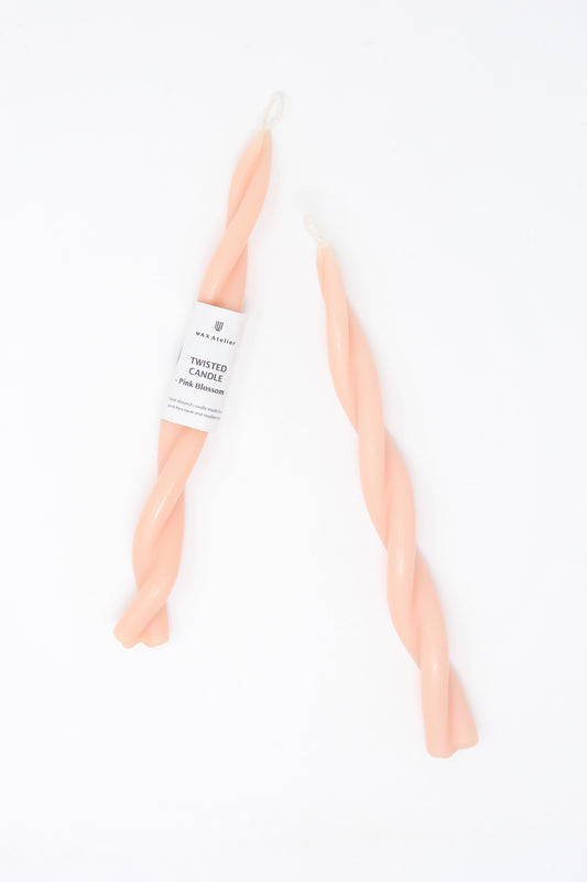 Two Hand Twisted Beeswax Candles in Pink Blossom by Wax Atelier on a white background.