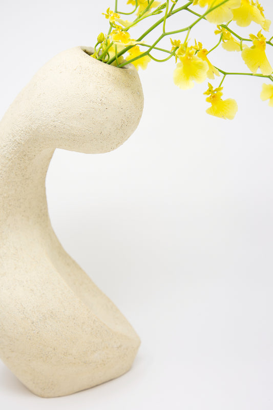Abstract Large Hand Built Vessel No. 000711 Bud Vase with yellow flowers against a white background, made from white sculpture clay by Lost Quarry.