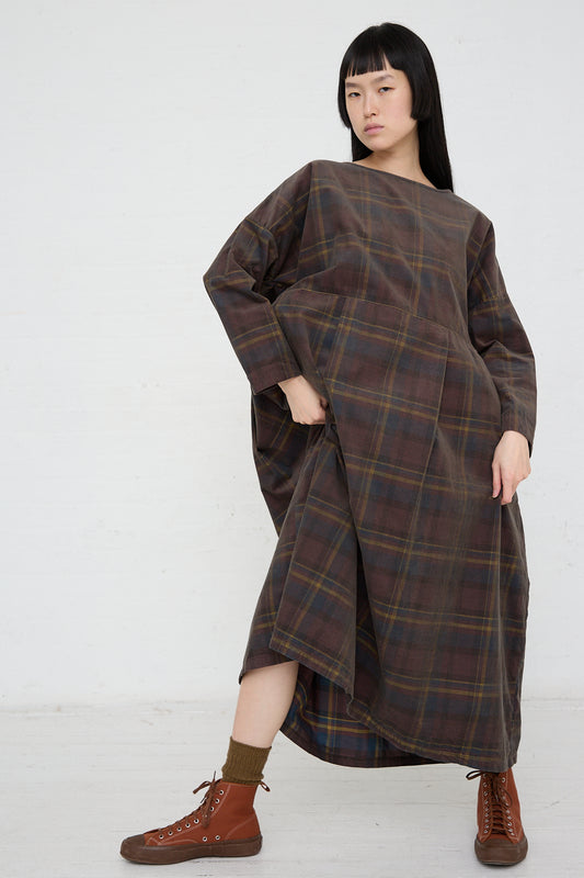 A woman wearing an Ichi relaxed fit, long sleeve Woven Cotton Dress in Brown plaid.