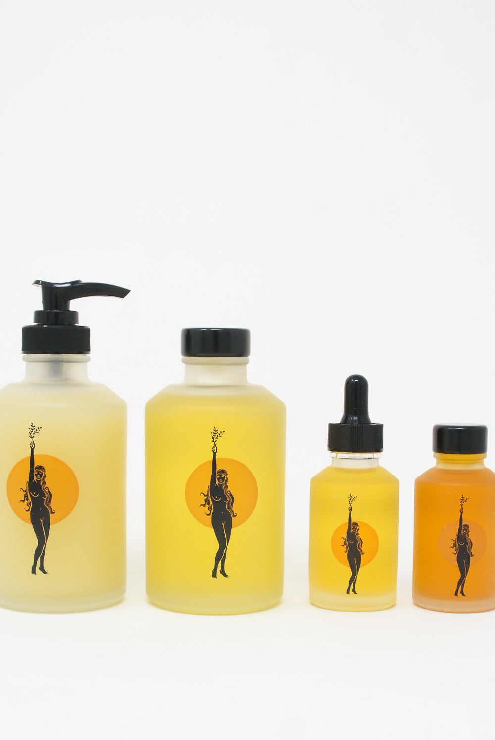A set of Wonder Valley bottles with a woman's face on them, containing natural oils and infused with the rejuvenating properties of honeysuckle.