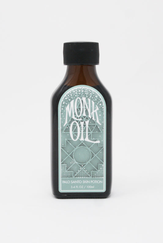 A bottle of Skin Potion in Palo Santo by Monk Oil on a white background.
