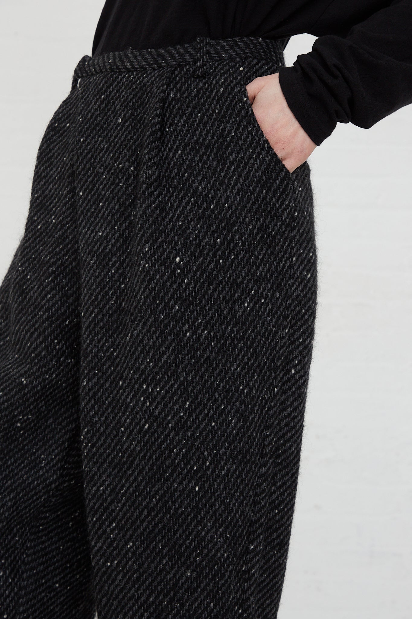 A woman wearing Snow Nep Wool Pant in Black trousers by Ichi Antiquités, featuring a wide leg cut.