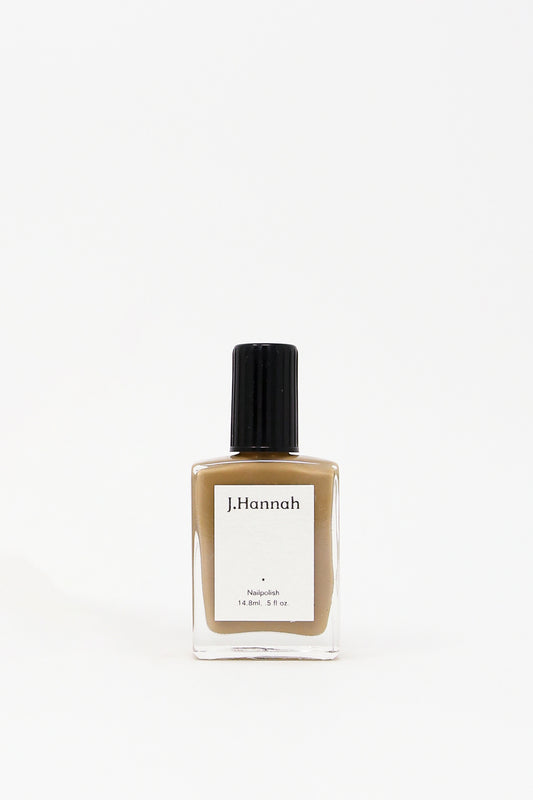 J Hannah Nail Polish in Dune (Brown/Earth Tone). Image of single nail polish against a wide background.