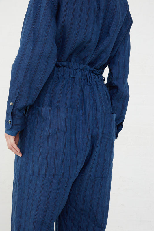 The back view of a woman wearing the Ichi Antiquités Woven Linen Pant in Indigo Stripes with an elasticated waist.