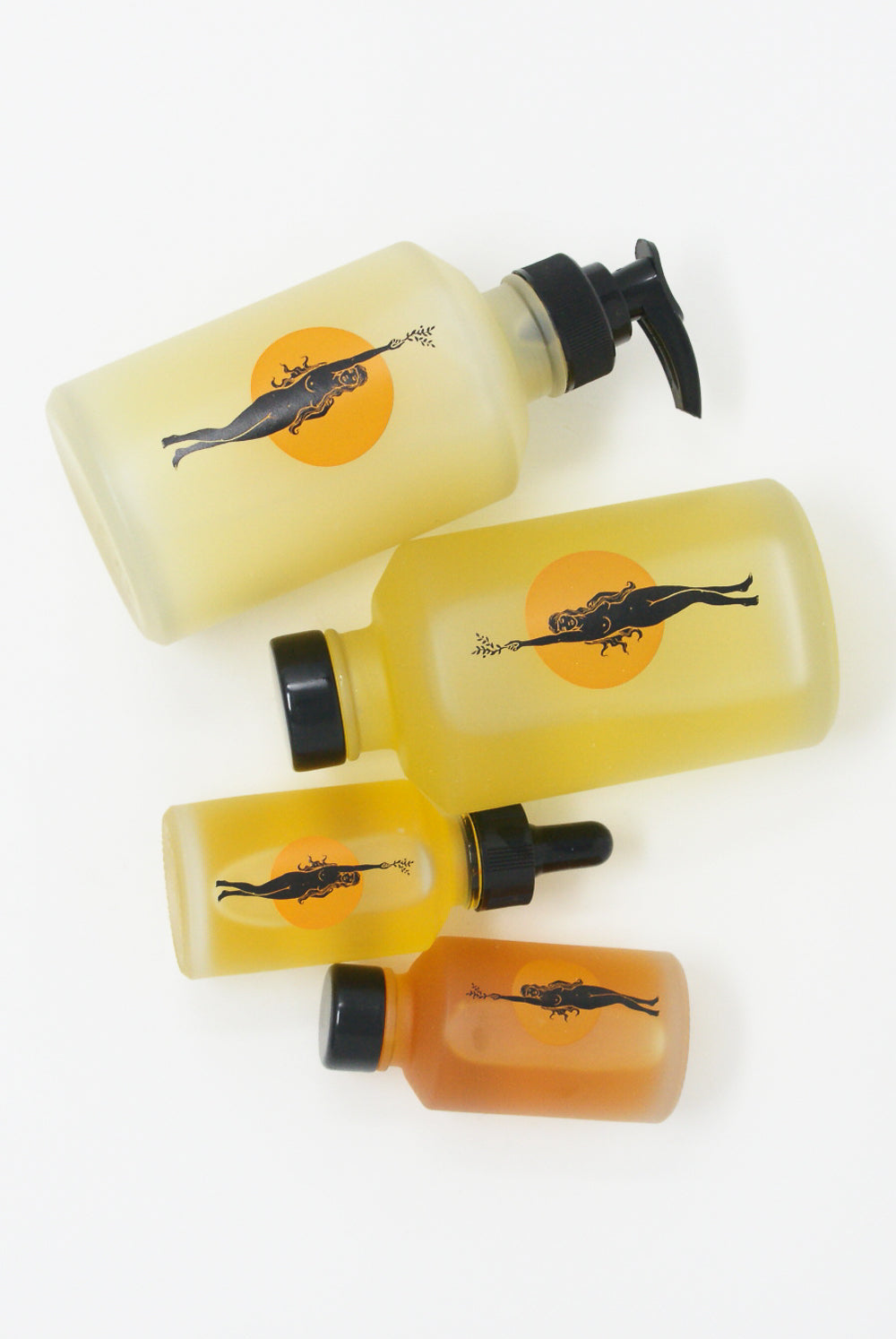 A bottle of Wonder Valley Facial Oil Cleanser, scented with honeysuckle, and a bottle with a drawing of a fish.