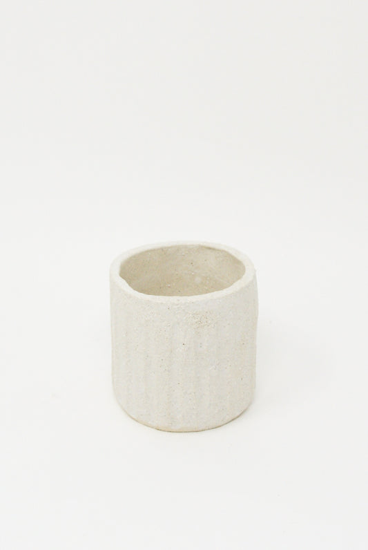 A small handmade ceramic Tea Cup in Natural by Clandestine on a white background.