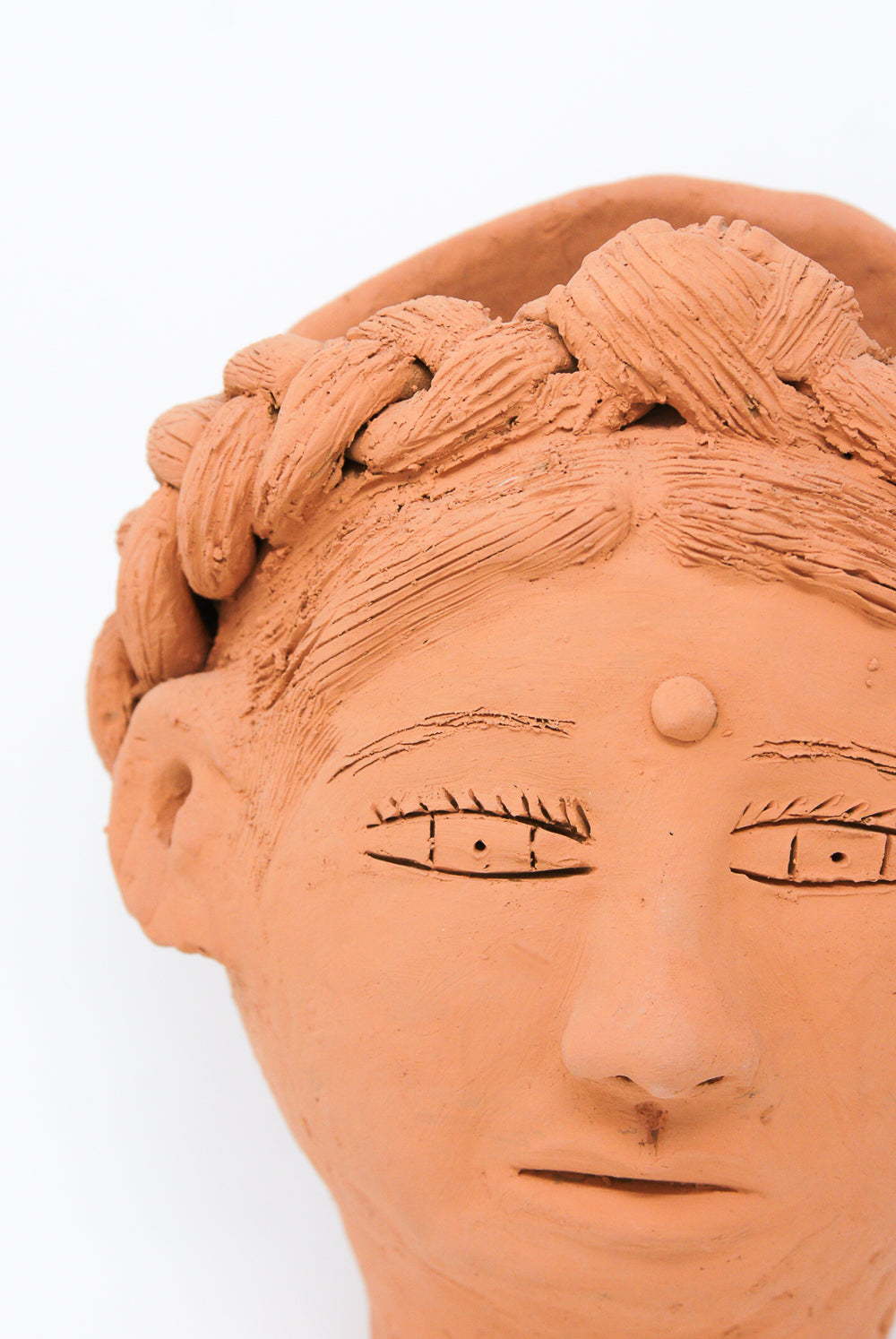Close-up of a Travel Find Large Head Planter in Terracotta from Oaxaca, depicting detailed hair and facial features.