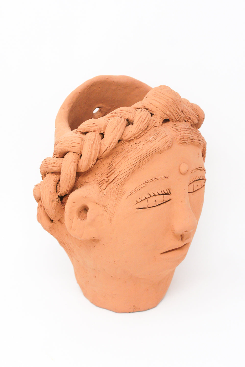 A Large Head Planter in Terracotta from Oaxaca of a stylized human head with detailed hair and facial features, designed as a large head planter by Travel Find.