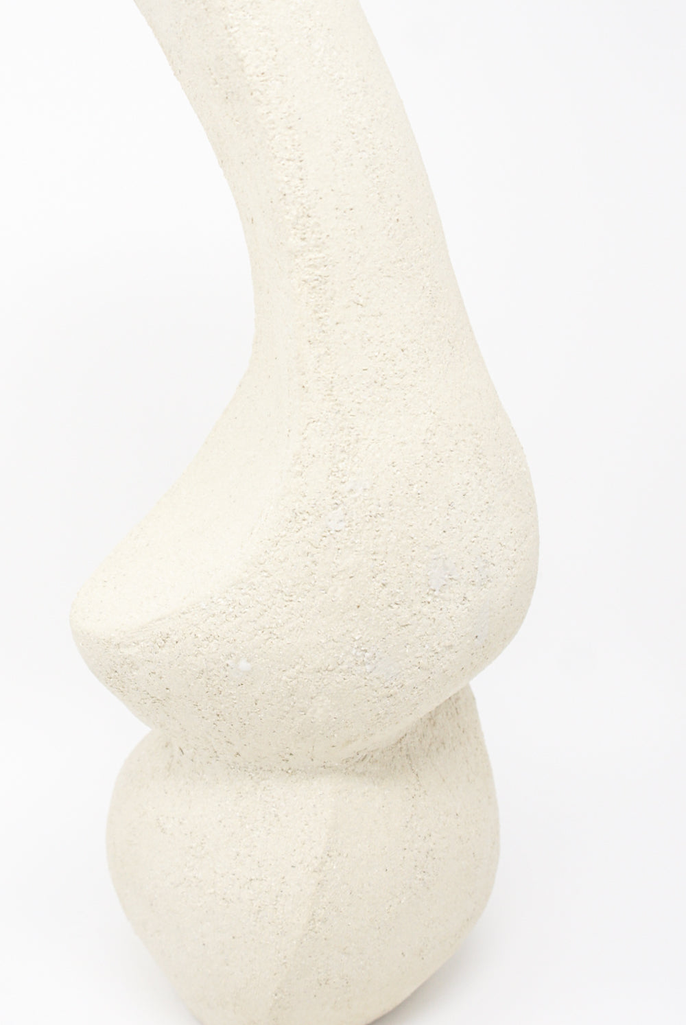 Hand Built Vessel No. 000345 by Lost Quarry is a white, textured abstract sculpture featuring a curving, elongated shape and rounded base, set against a plain background.