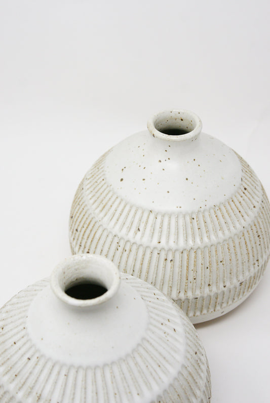 Two Mt. Washington 6" Tulip Vases with a speckled white glaze on a white background.