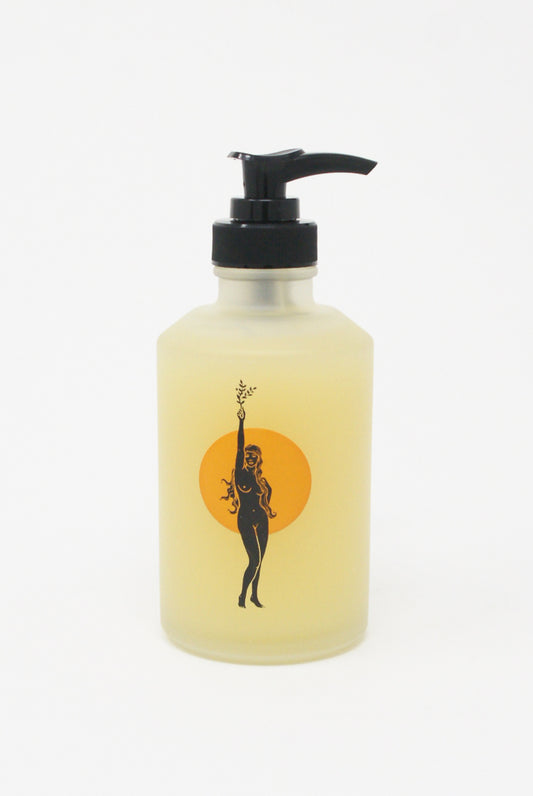 A bottle with an image of a woman holding a bottle of Wonder Valley Facial Oil Cleanser.