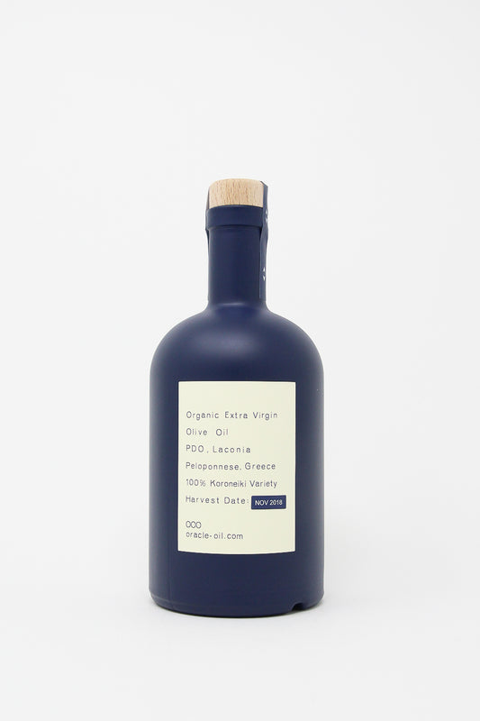 A bottle of organic Oracle Oil - Olive Oil with a blue label on a white background.