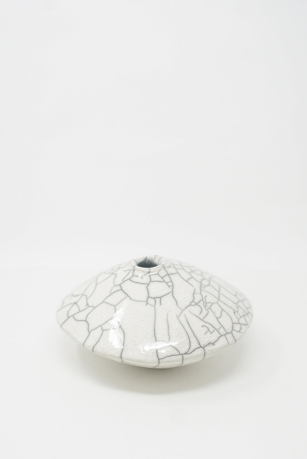 A white, crackle-glazed Ikebana Vase in Raku-Fired Stoneware dish from MONDAYS on a plain background.