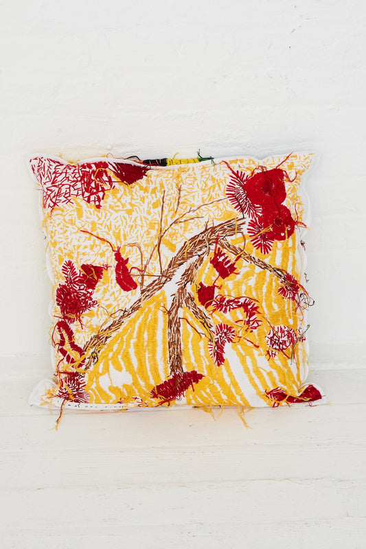 A Luna Del Pinal Hand Embroidered Harvest Topographic Cushion with flowers on it.
