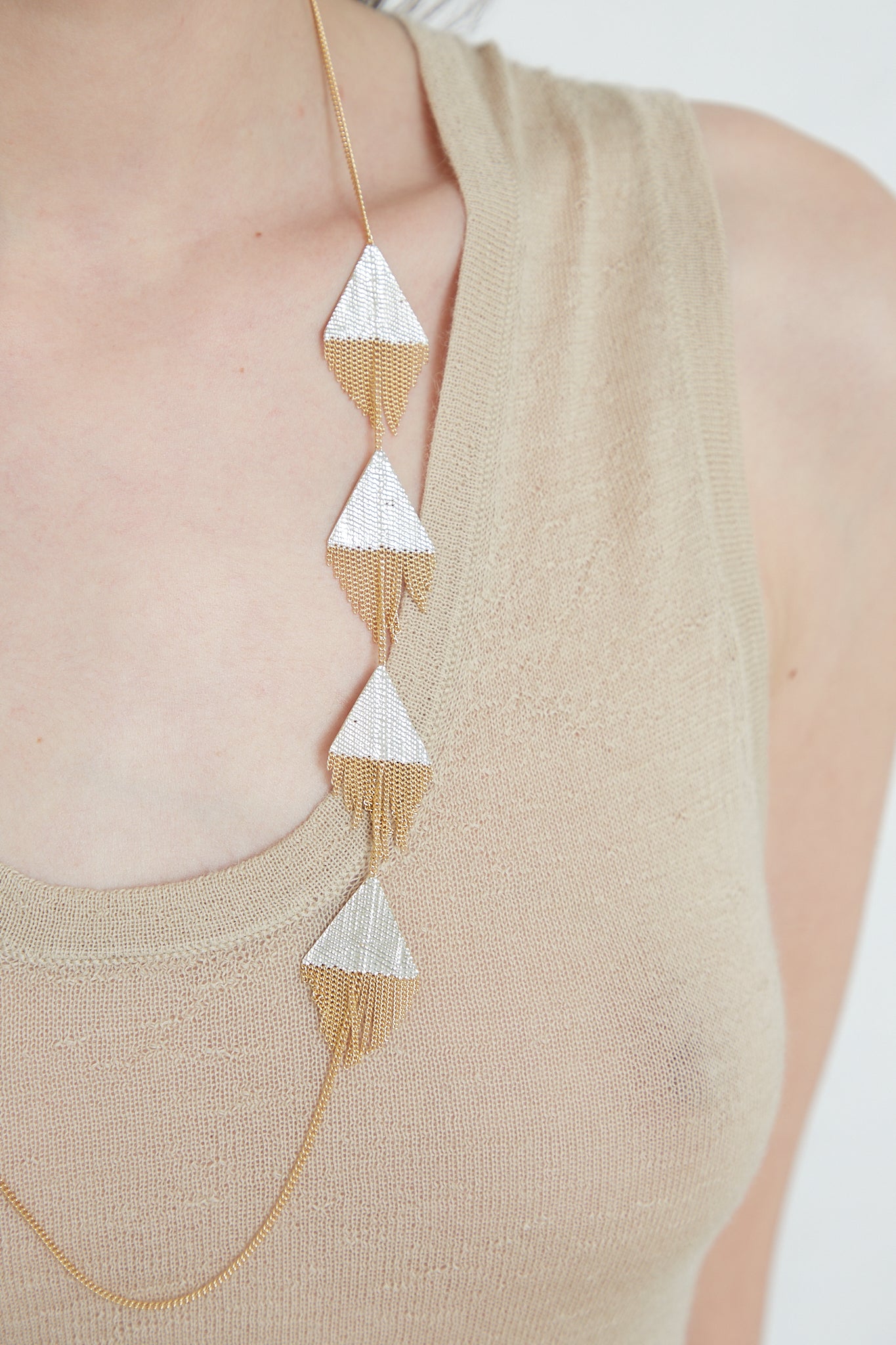 A Hannah Keefe Triangle Necklace in Brass Chain and Silver Solder featuring delicate triangles crafted from brass and silver solder.