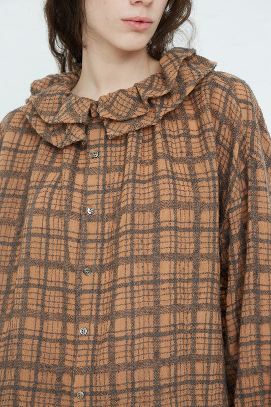 A model wearing a Wool Check Frill Blouse in Terracotta from Ichi Antiquités.