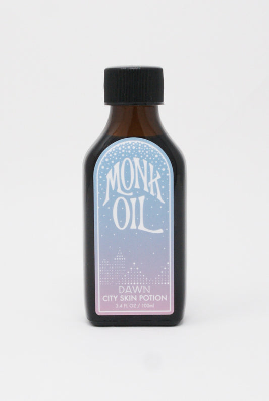 An organic Skin Potion in Dawn bottle of Monk Oil on a white background.
